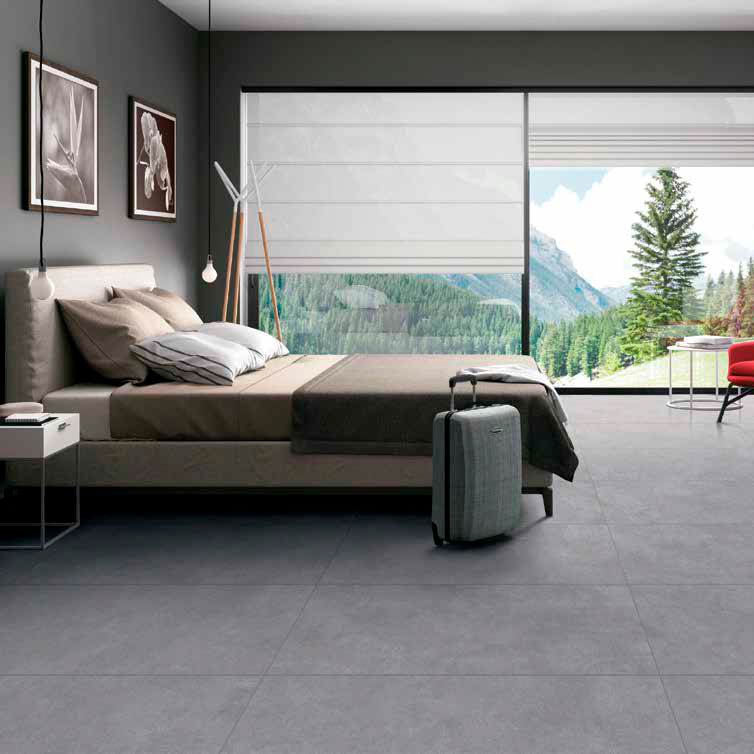 Recámara moderna con piso gris tipo porcelanato y ventana panorámica con vista natural